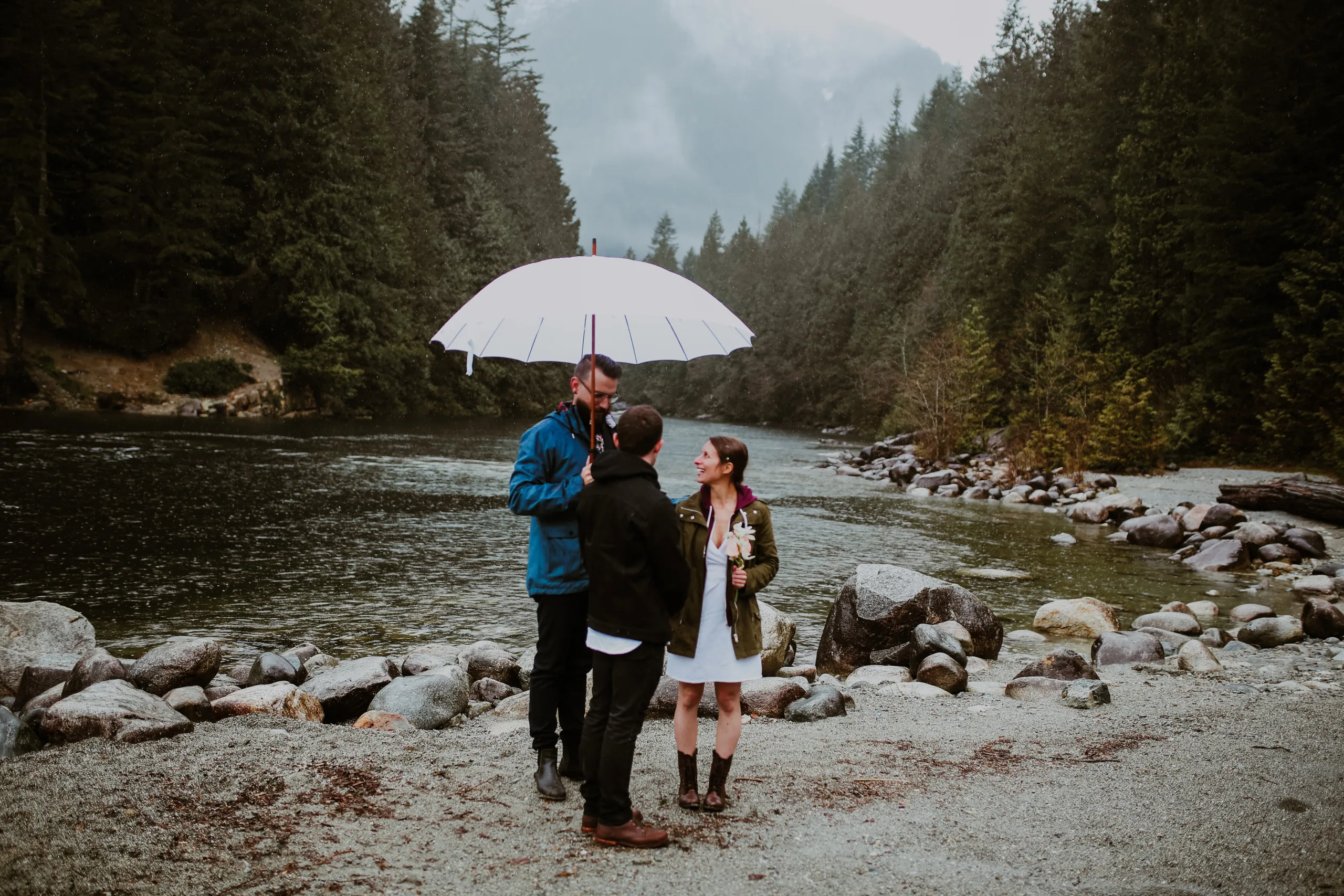 Shawn officiating an elopement in the rain with Caitlin and Christopher