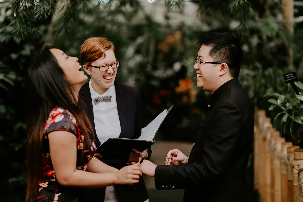 Officiant Beth laughing with a couple during their Bloedel Conservatory elopement