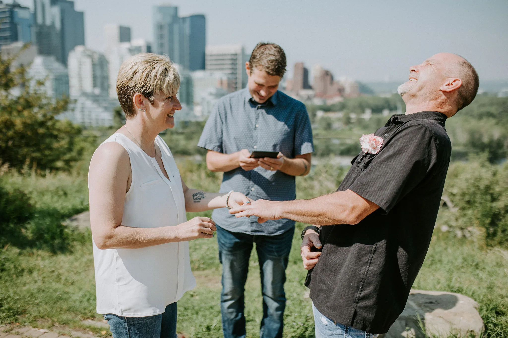 Couple laughing during the ring exchange of their Rotary Park Calgary elopement