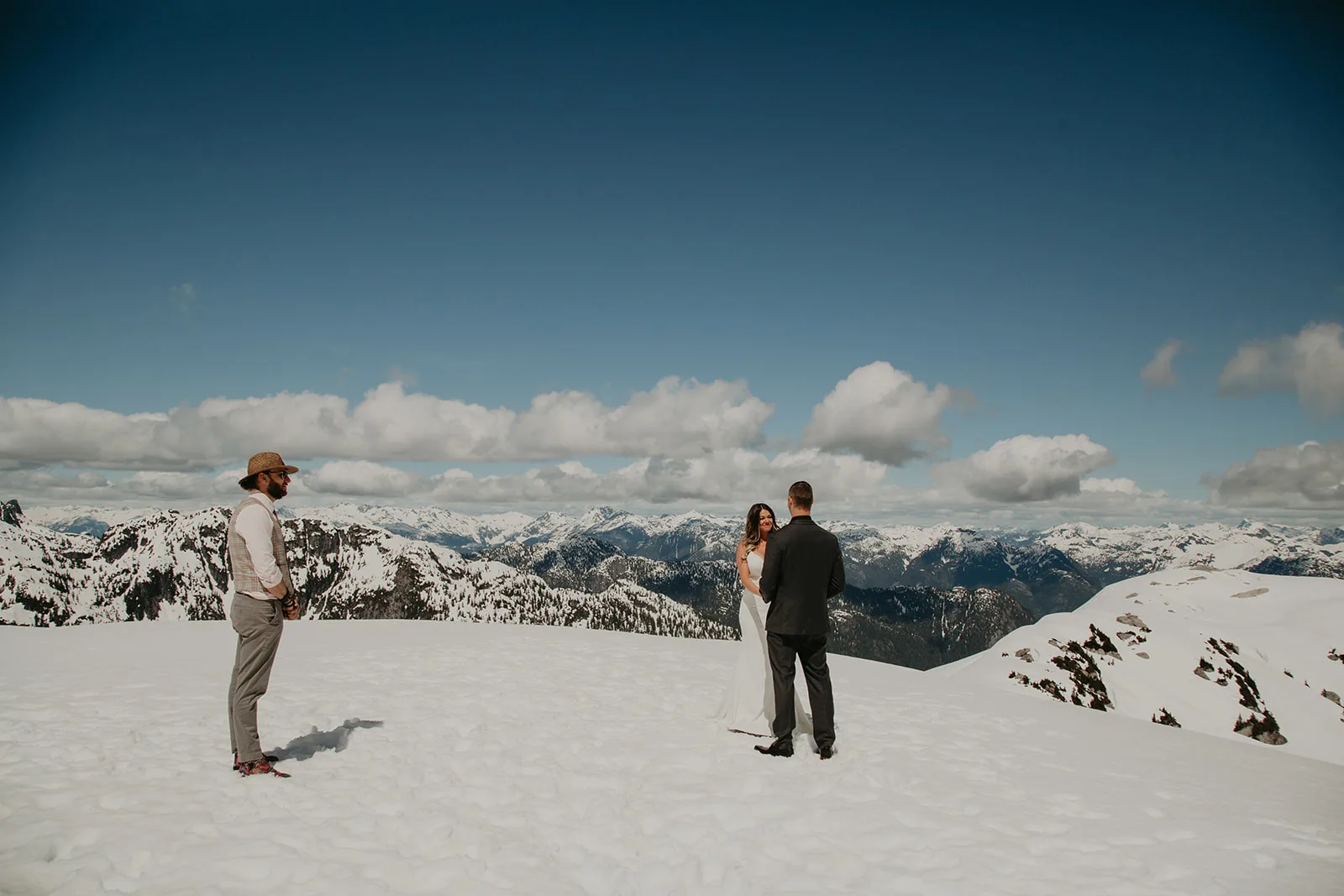 Shawn Miller officiating a helicopter elopement on a snowy mountaintop