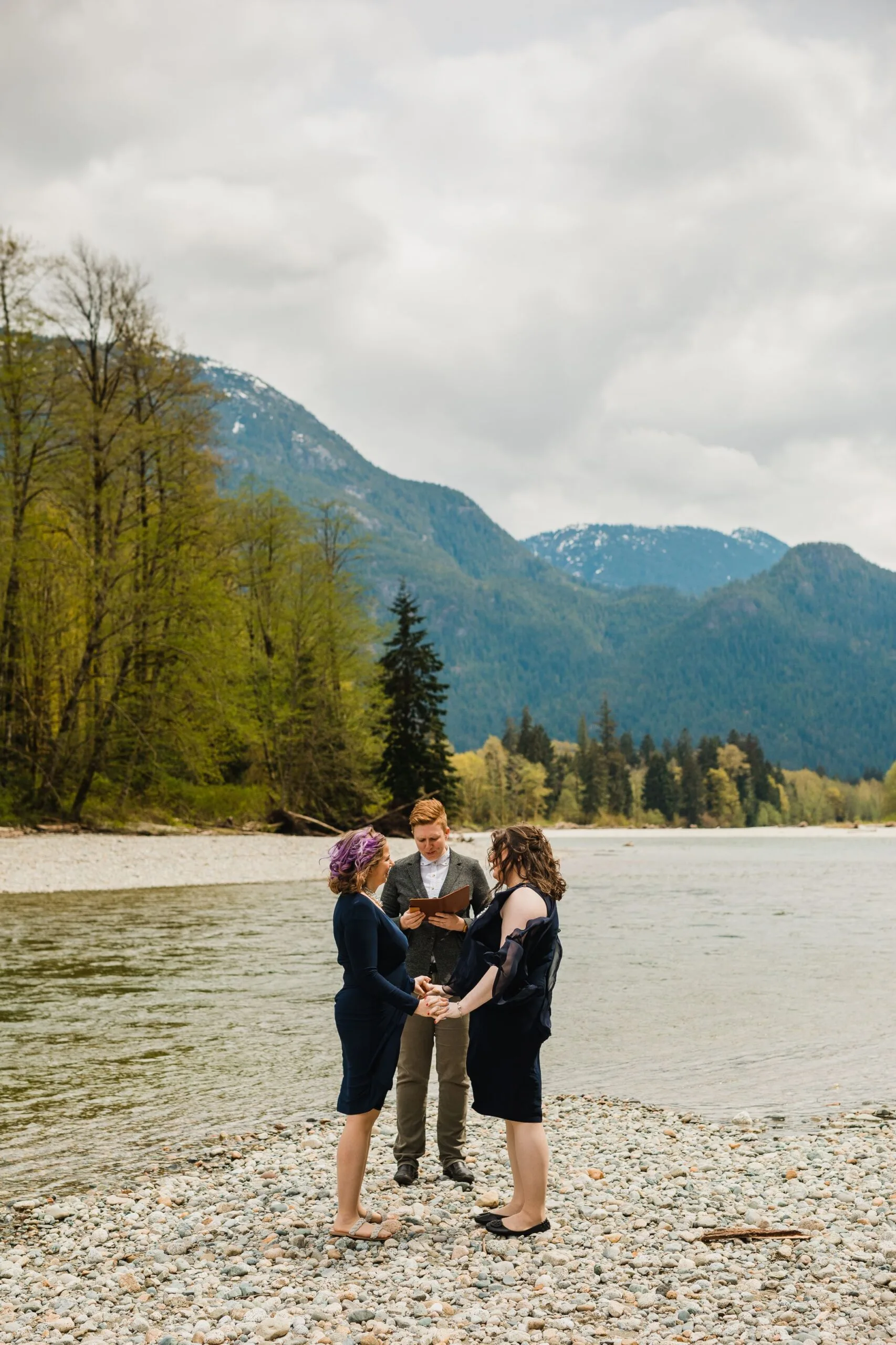 Officiant Beth with a newlywed couple during their helicopter elopement with young hip and married