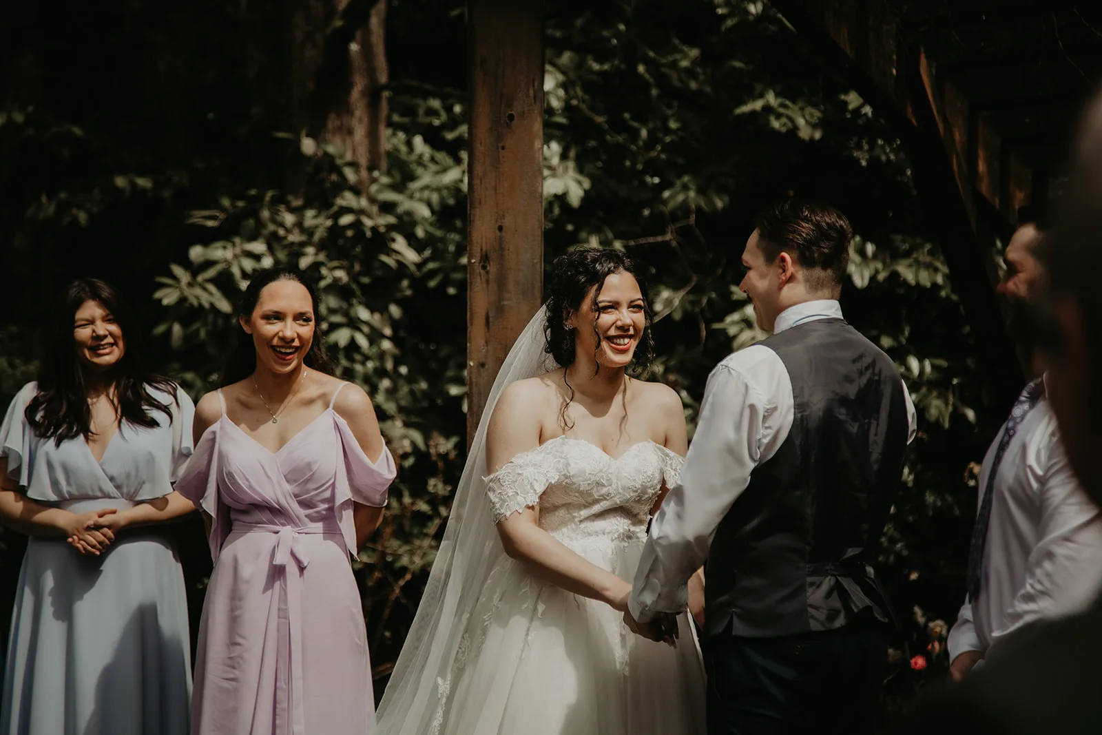 newlywed couple with their wedding party during with ceremony with young hip and married wedding officiants elopements