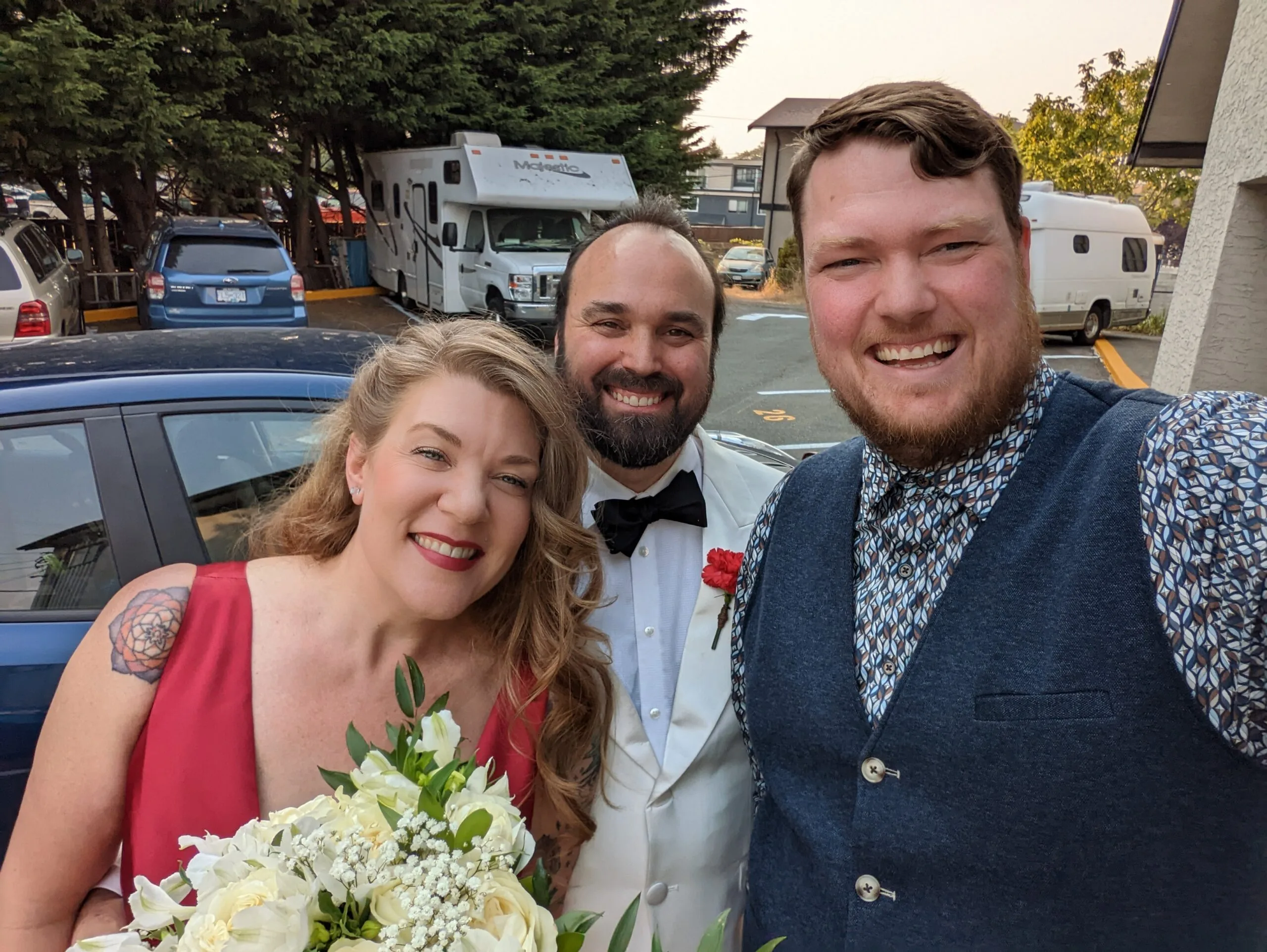 Selfie of Officiant Jordan with newlyweds Megan and Ariel