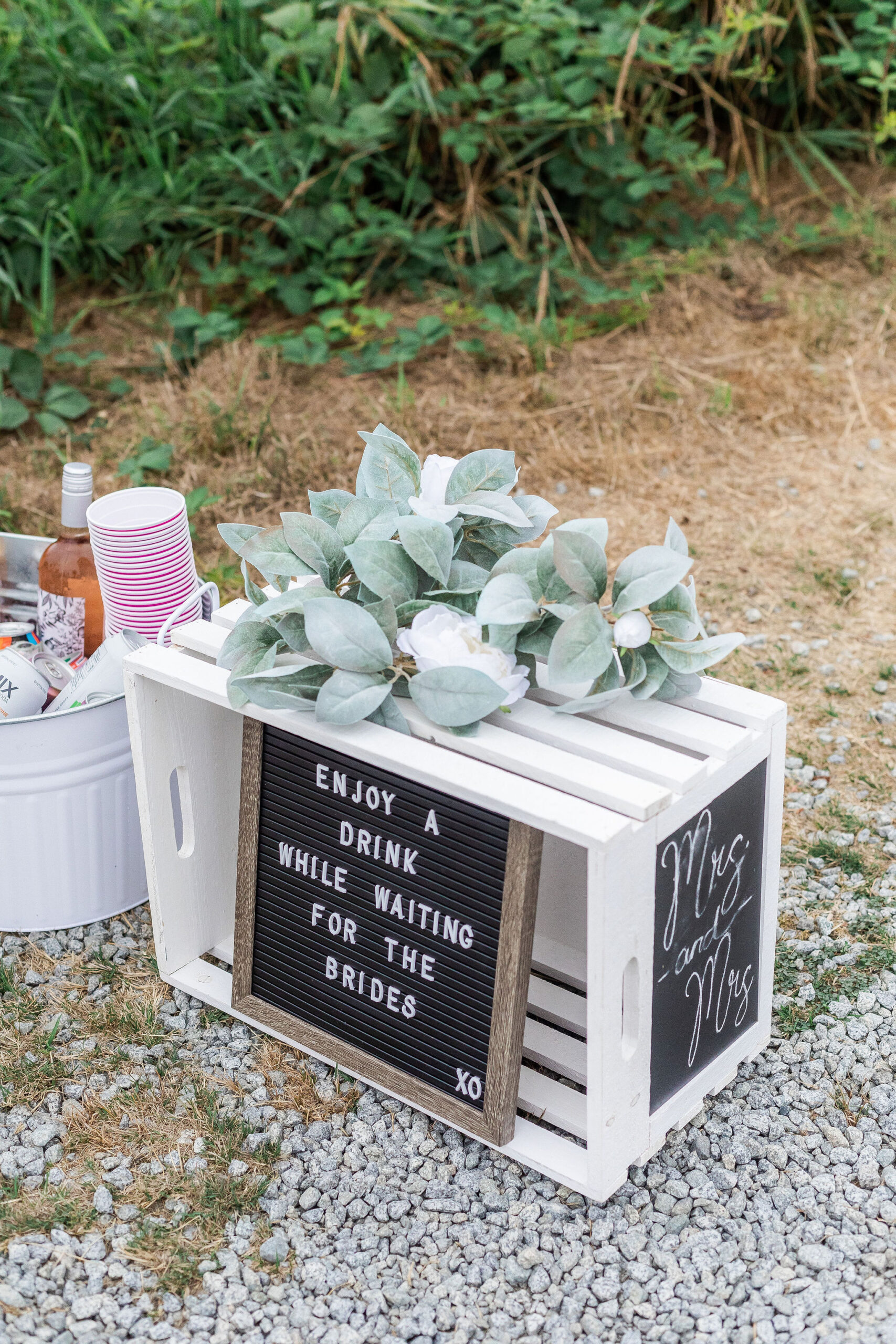 fun ideas for your wedding ceremony like a sign encouraging guests to enjoy a drink before the ceremony that says "enjoy a drink while waiting for the brides" 
