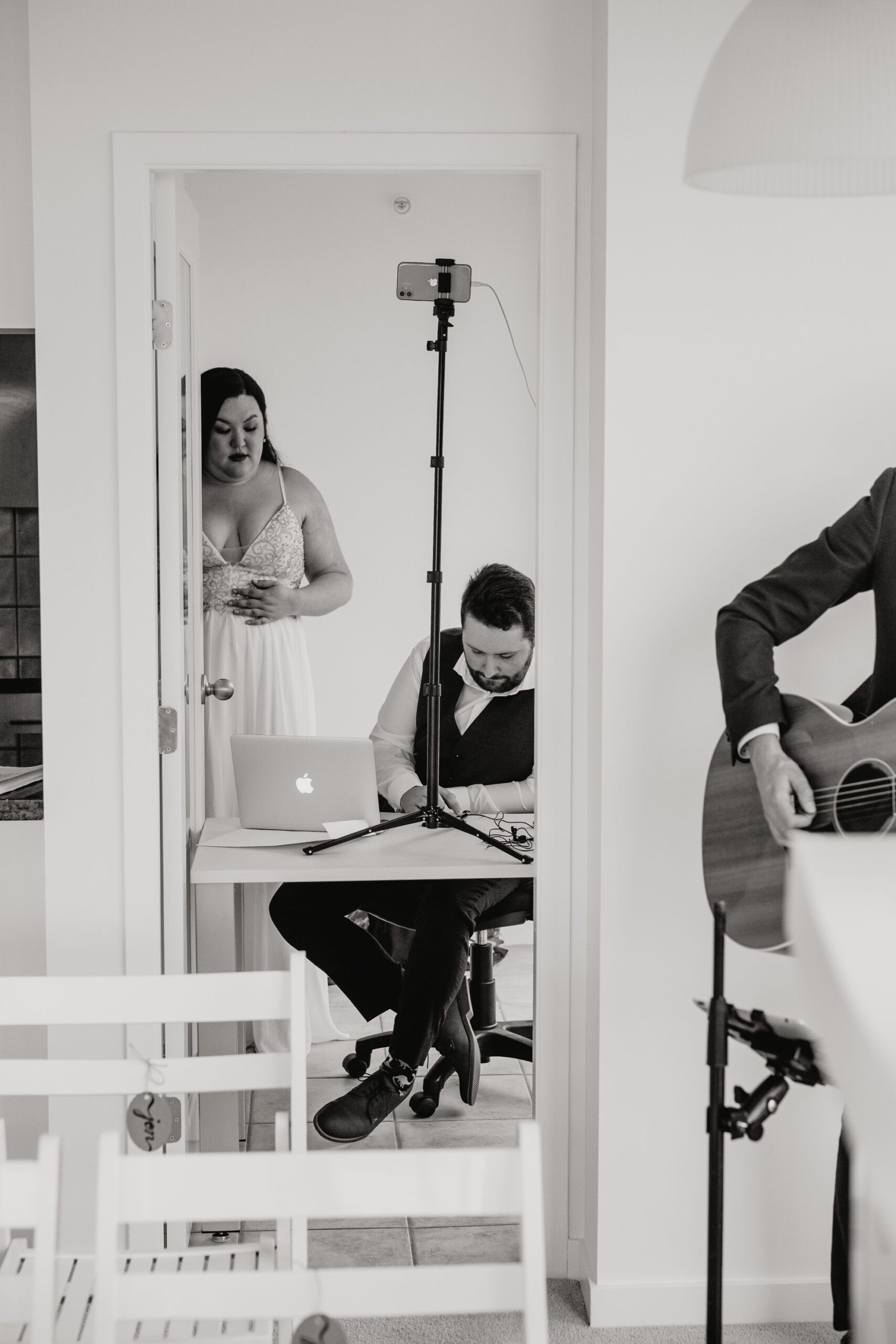 bride and groom set up the tech for the virtual wedding to live stream to guests