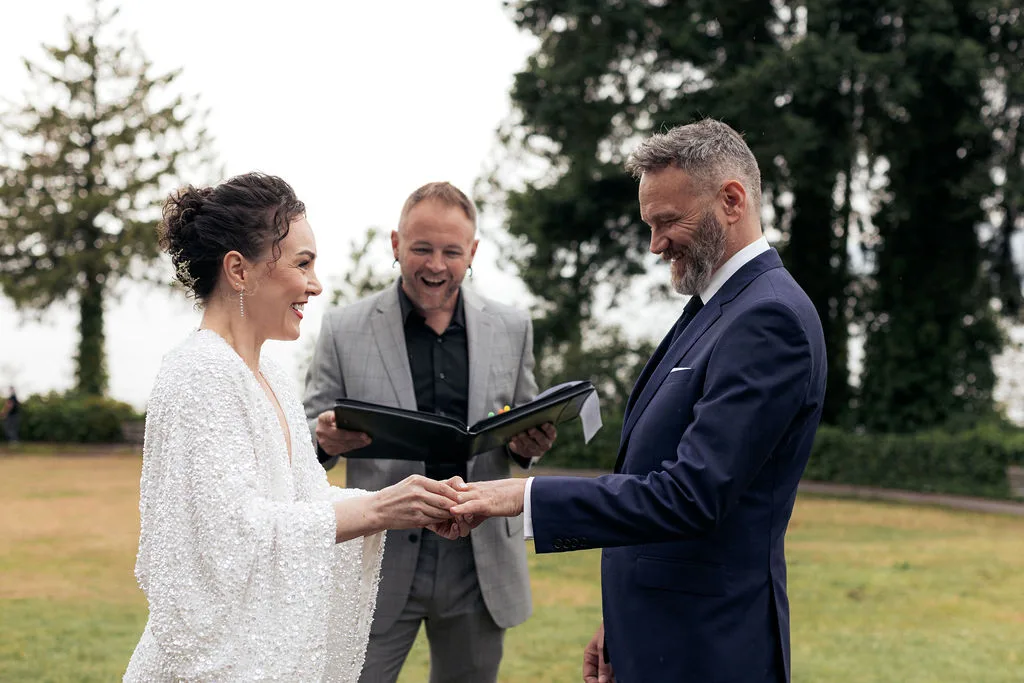 Anna and Scott exchanging rings during their elopement with Officiant Shawn G