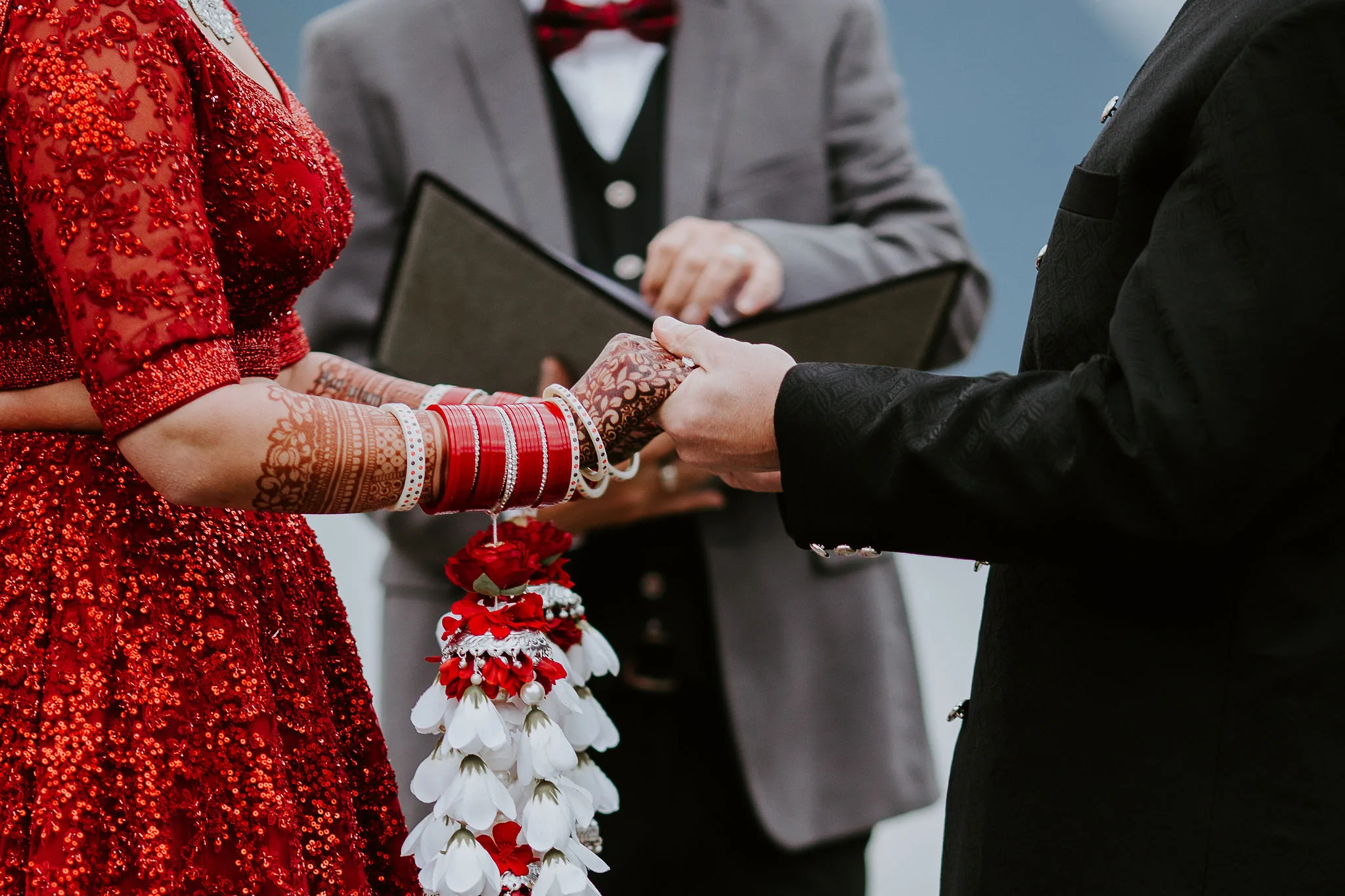 newlywed couple holding hands during ceremony