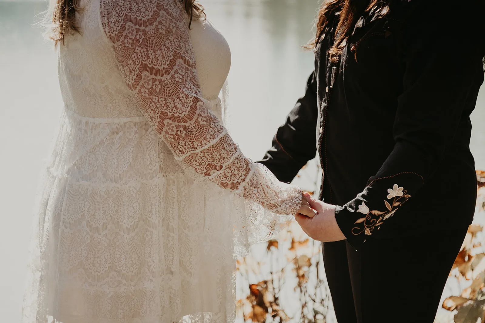 Two partners holding hands during their elopement ceremony
