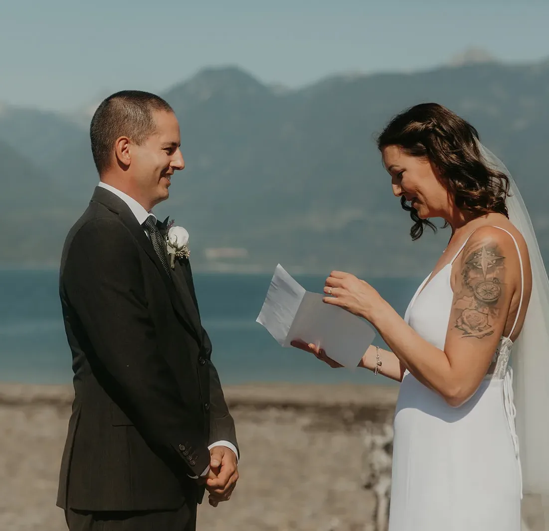 Bride and groom exchanging vows during their elopement on the beach