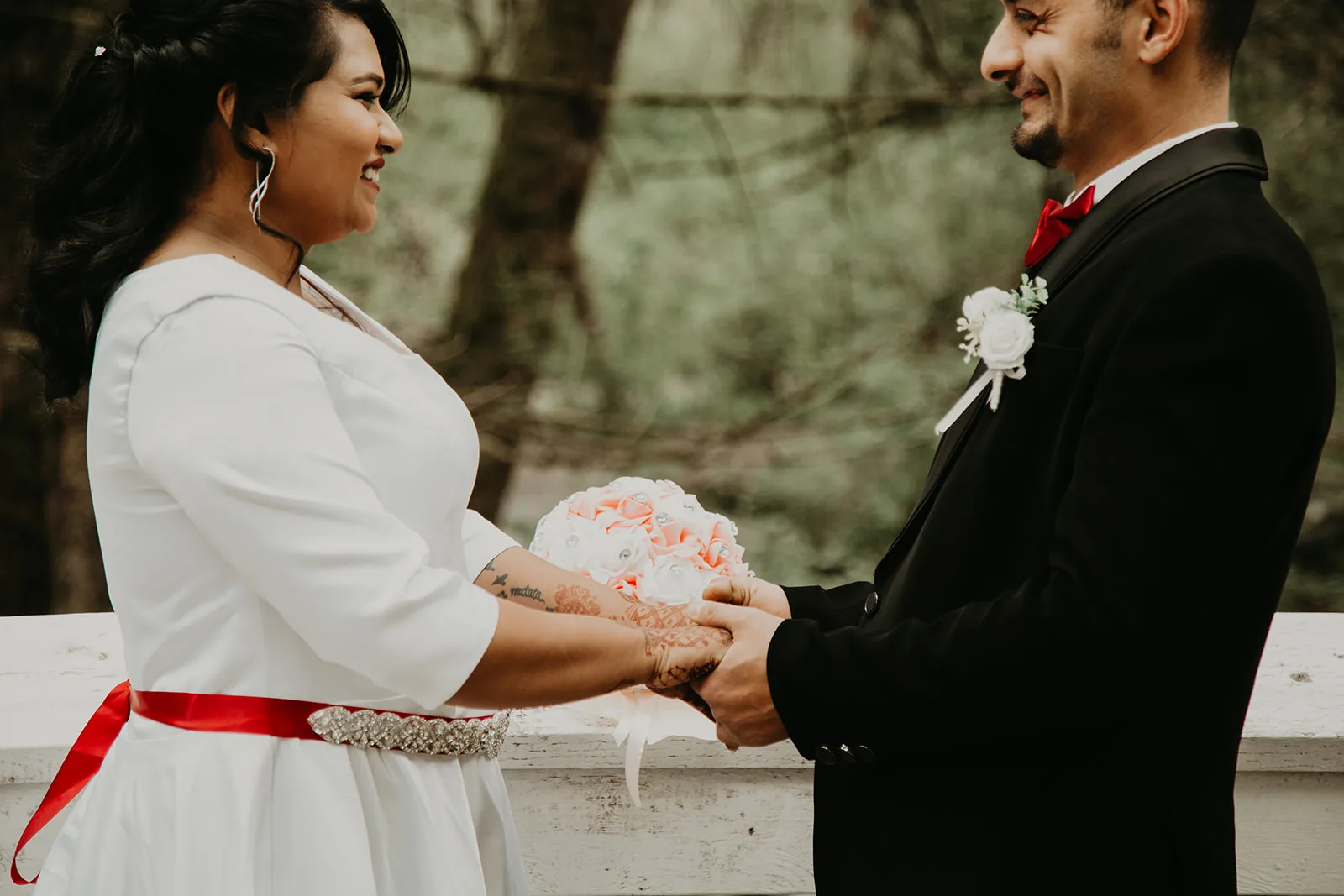 Newlywed couple holding hands during their ceremony