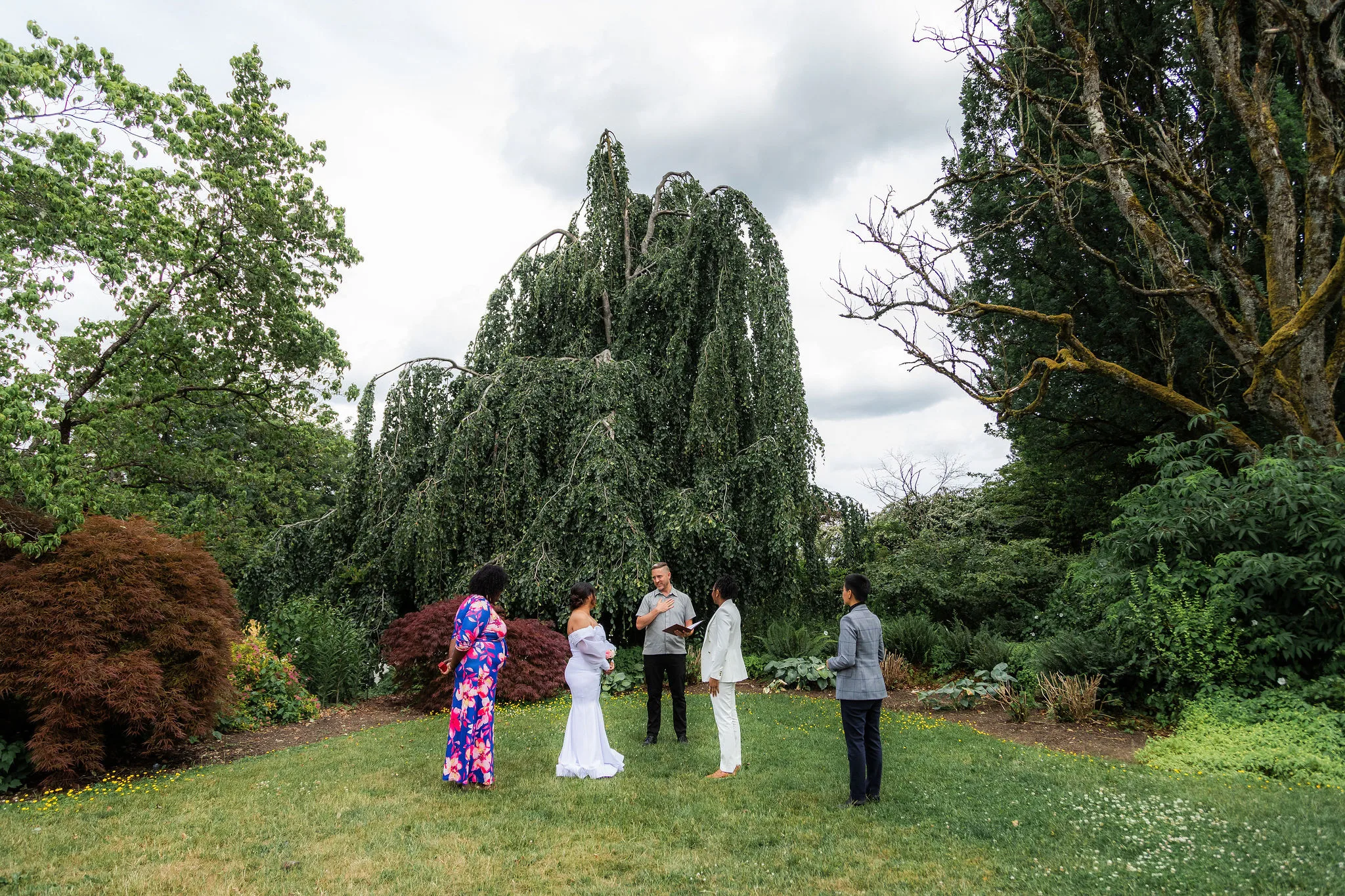 Officiant Wade leading an elopement ceremony in a Vancouver park