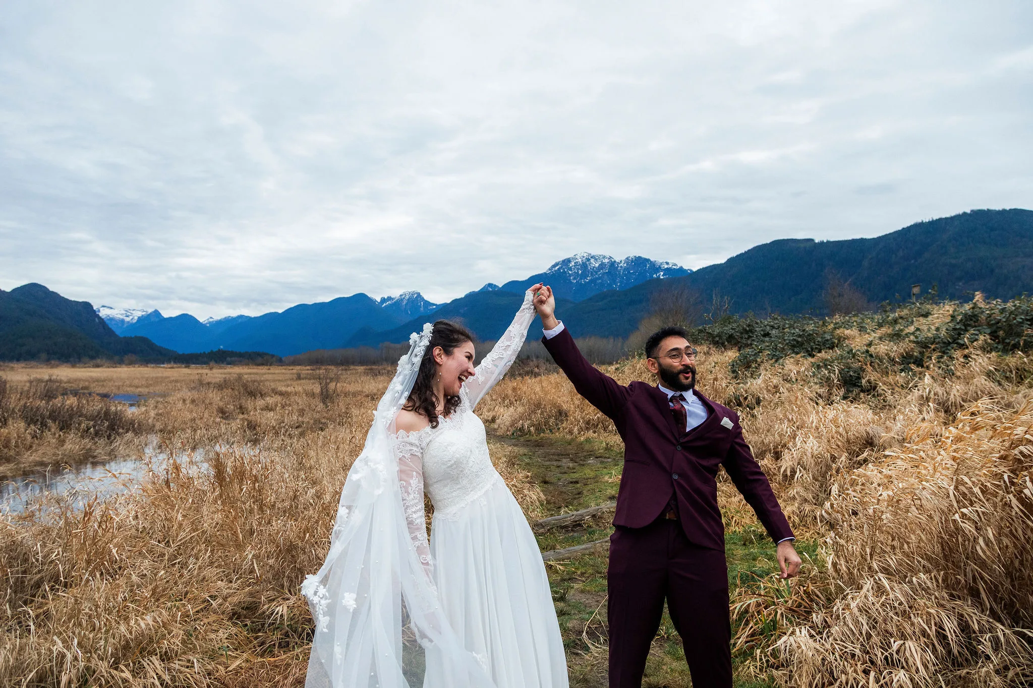 Bride and groom celebrating after their elopement with hands up in the air