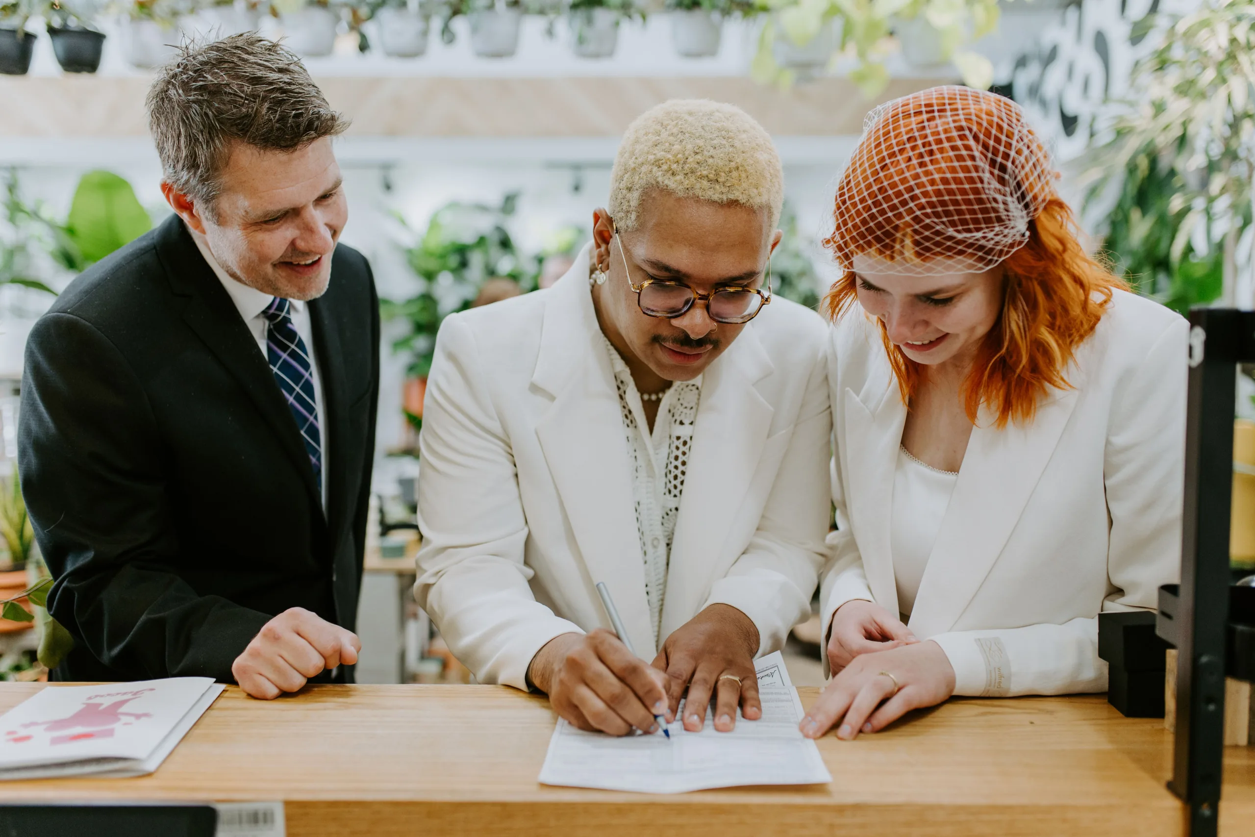 Joanna and Jacob signing their marriage licence with Officiant Rich, Deanna Rachel Photography