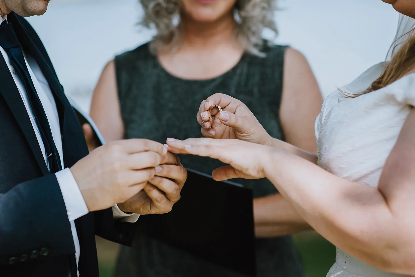 Ashley and Rhys exchanging rings at their ceremony with Officiant Amanda from Young Hip & Married, Jades Photography