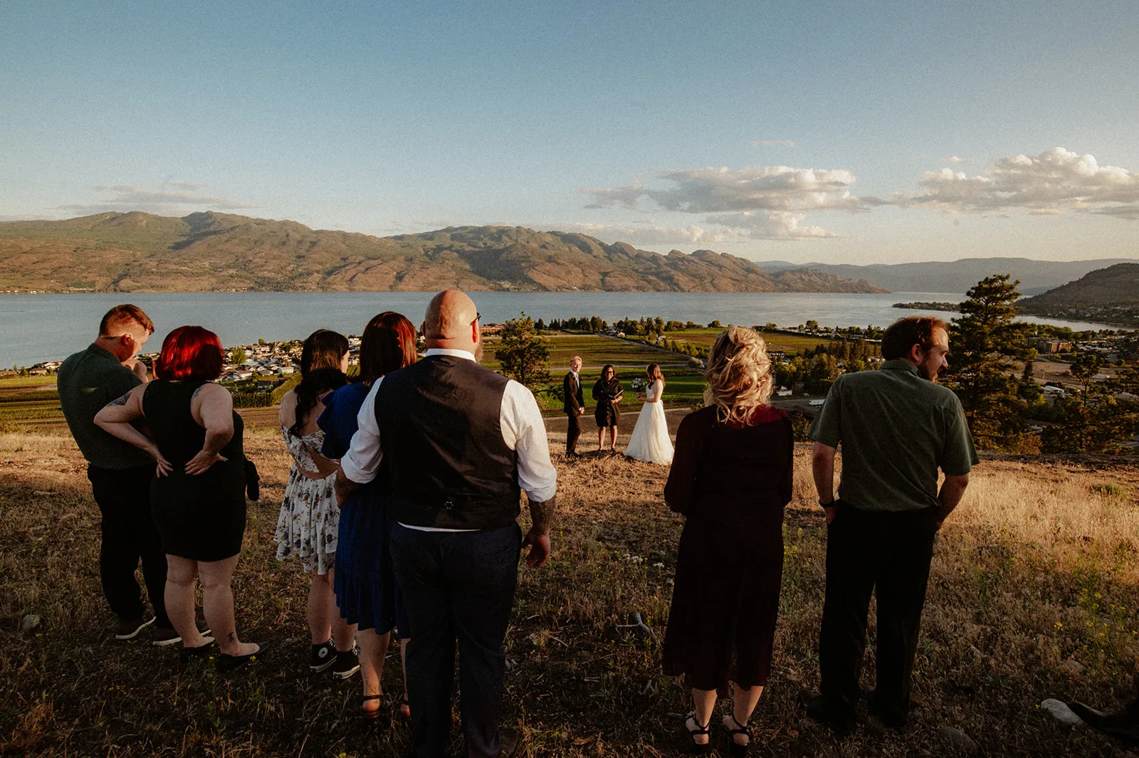 Rachel and Daniel's guests gather outdoors for their elopement in their nice clothes for wedding guests, Kayla Bowie Creative