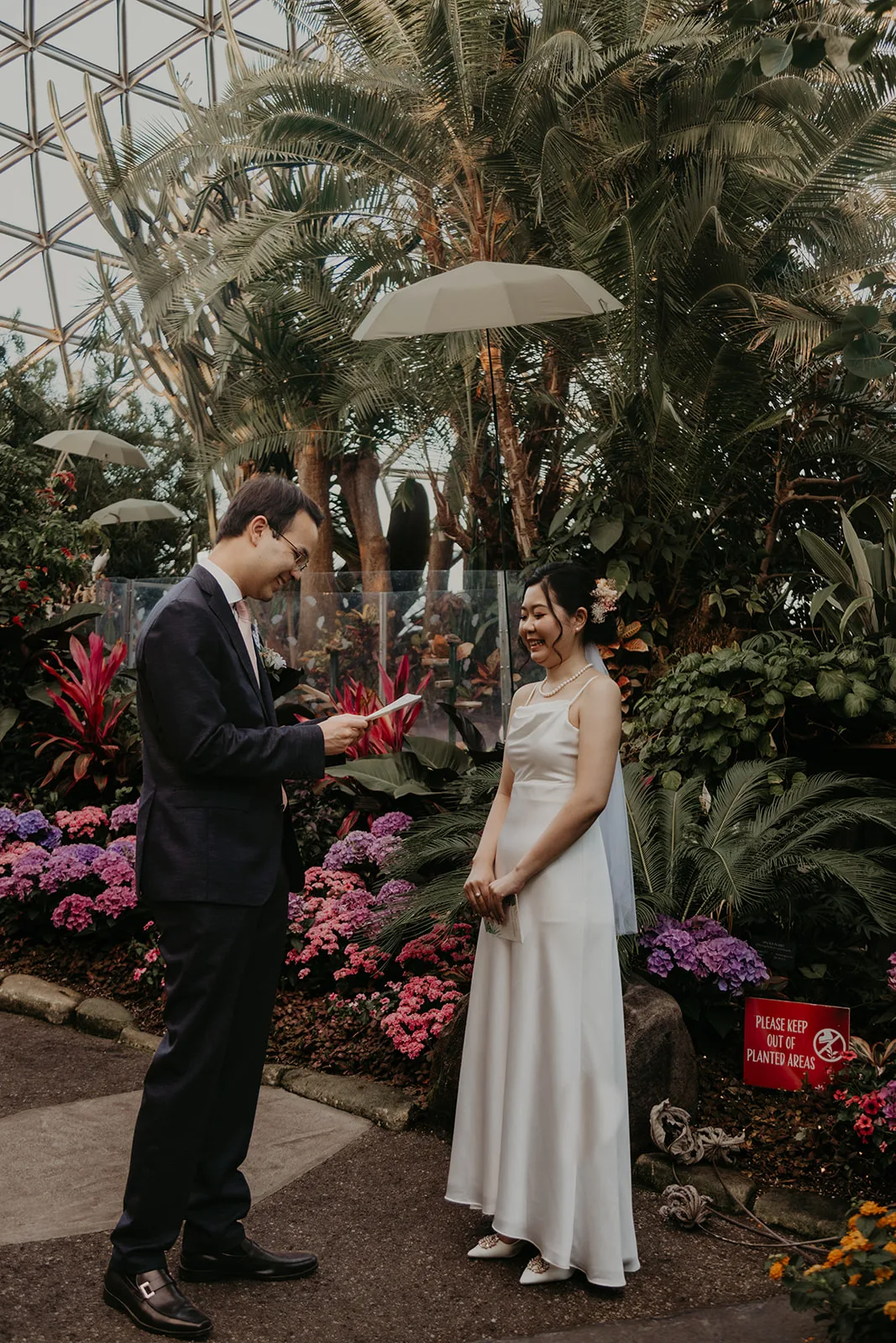 Kaho and Jade exchanging vows at their Bloedel Conservatory wedding, how to end your wedding vows, Erica Miller Photography