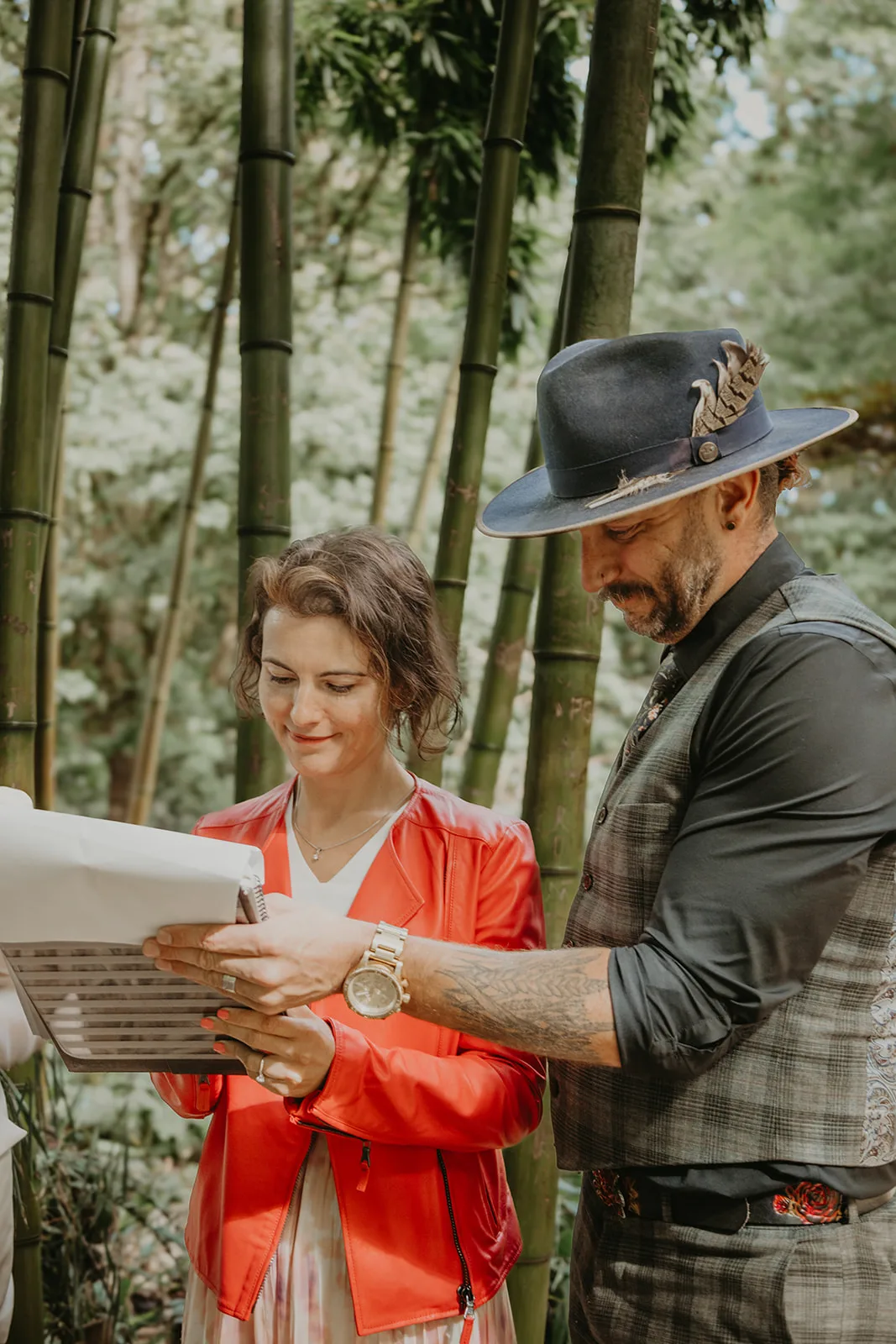 Officiant Shawn helps a wedding witness sign the licence, Erica Miller Photography