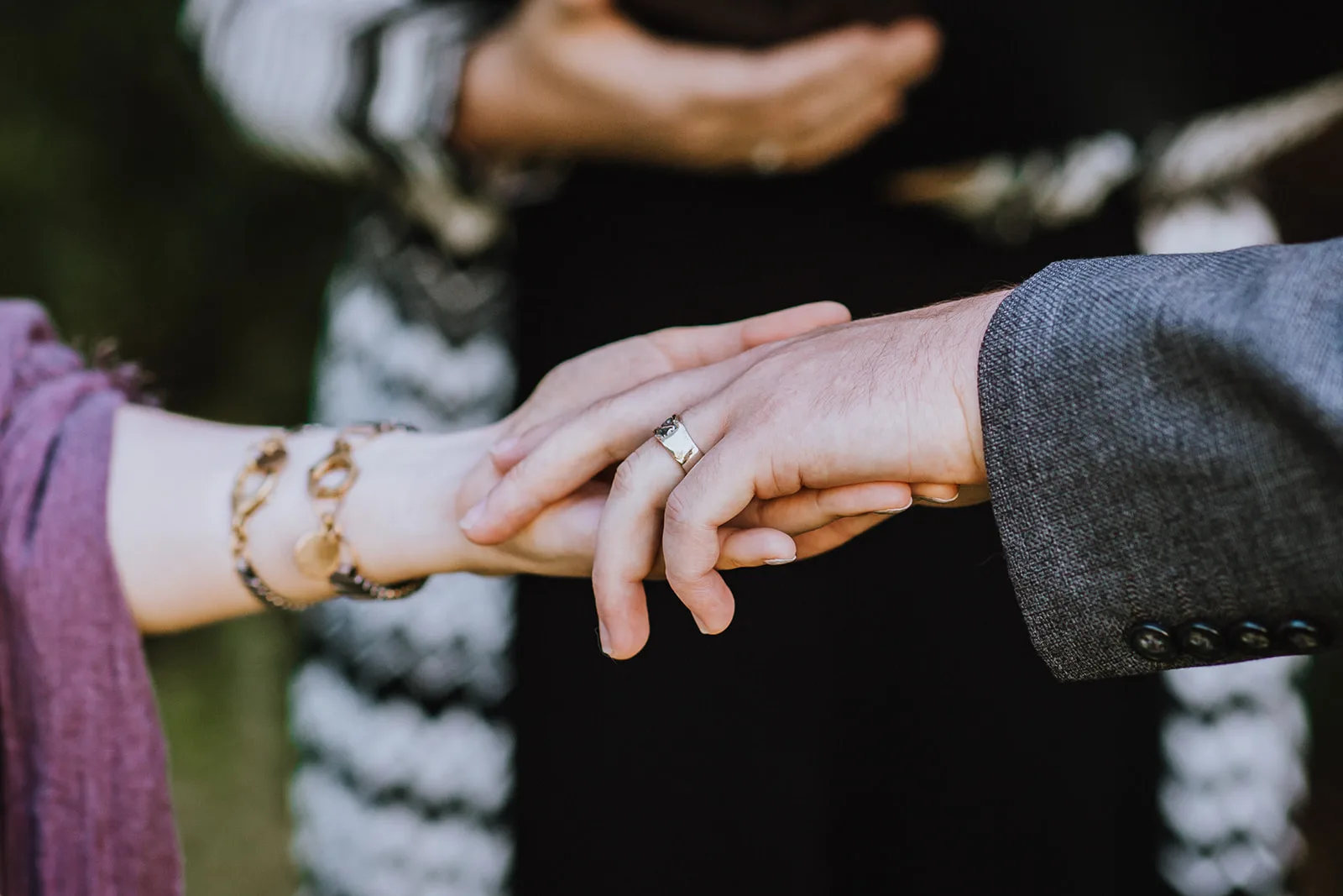 Alexandra and Evan holding hands during their wedding ceremony, Jades Photography